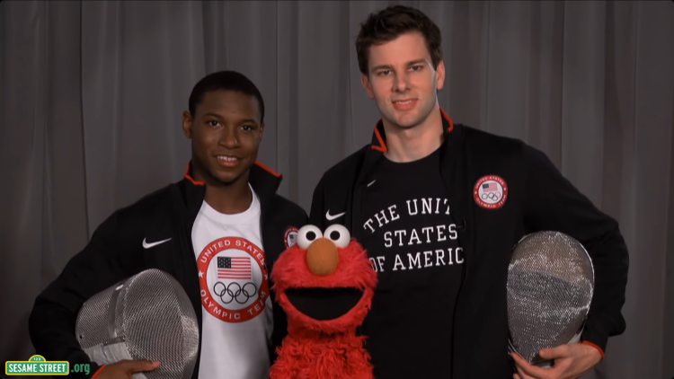 Elmo poses with two Fencing Olympians
