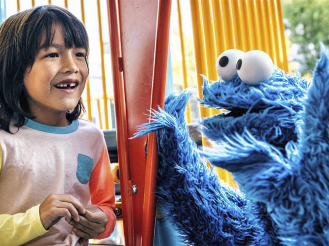 Child and Cookie Monster on a playground