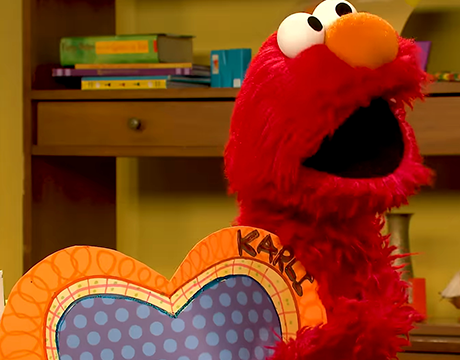 elmo holding a paper heart with Karli's name