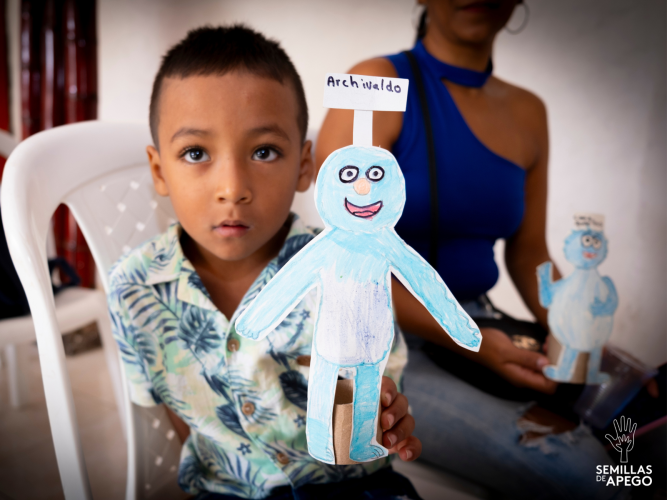 Child holding a paper-craft.