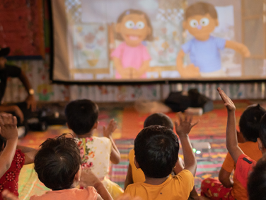 Children raising their hands in a classroom