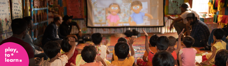 Children raising their hands in a classroom