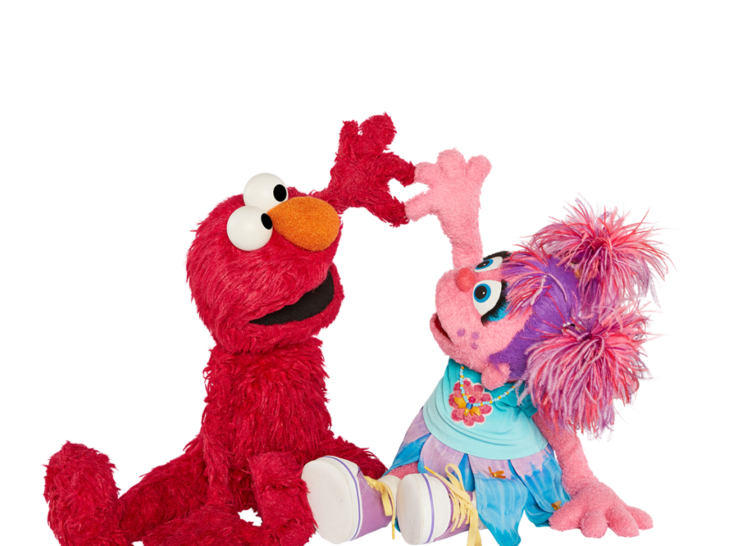 Elmo an Abby making a heart with their hands.