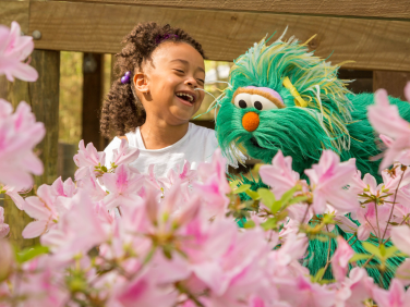 Child with Rosita surrounded by flowers