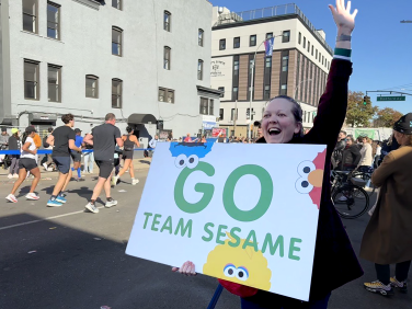 A bystander cheering for the NY marathon with a 