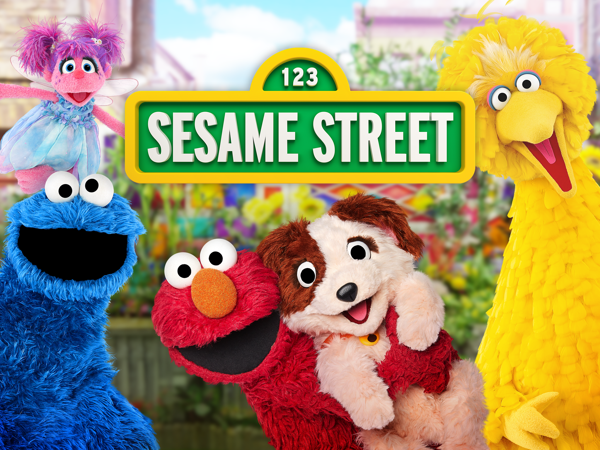 Abby, Cookie Monster, Elmo, Tango and Big Bird around the Sesame Street sign.