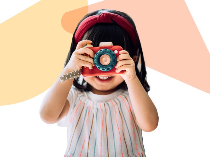 Child holding a camera.