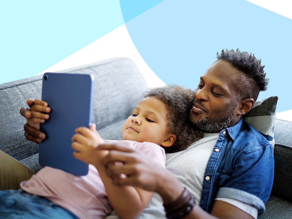 A parent and child looking at a tablet.