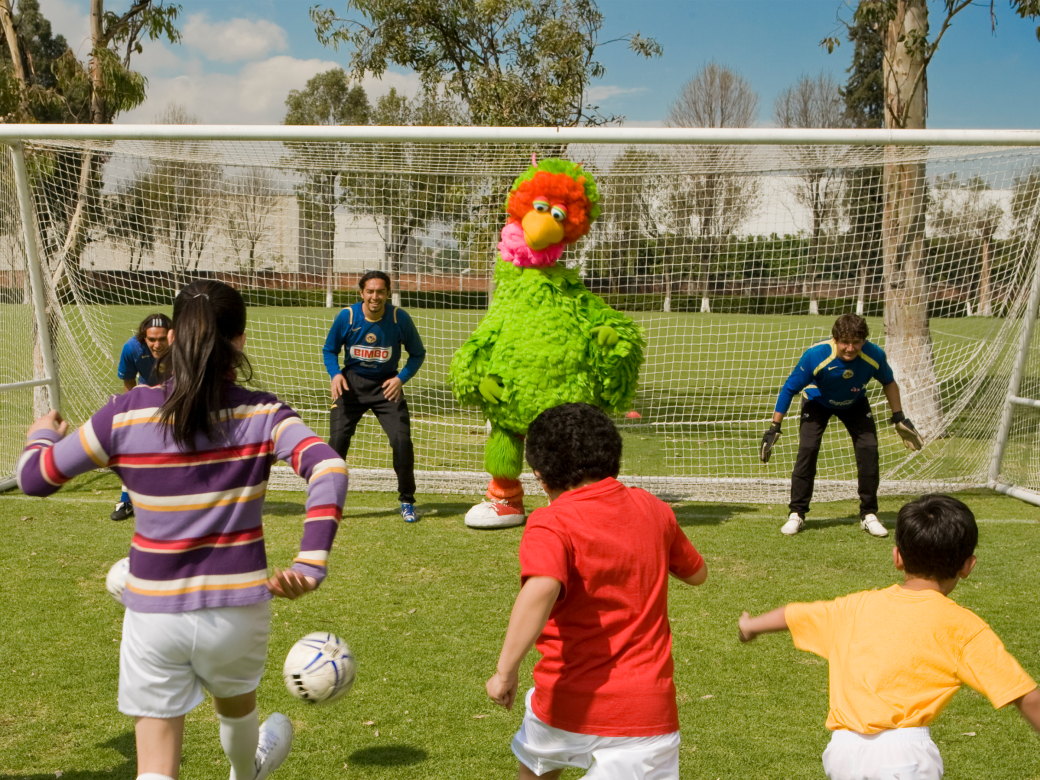 Abelardo and children playing soccer.