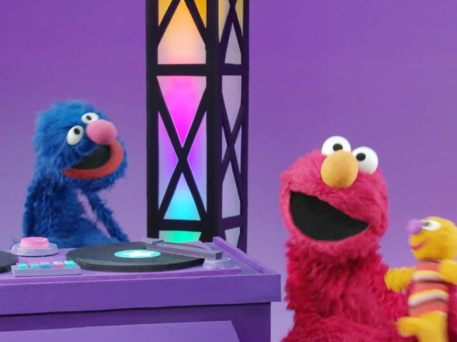 Elmo and Grover dancing.