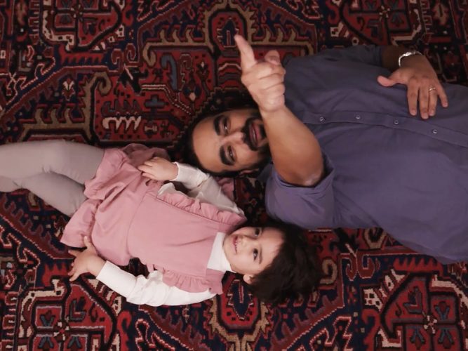 Father and child laying on the ground
