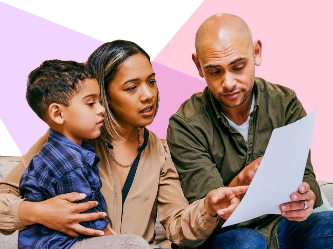 Adults and child looking at a piece of paper.