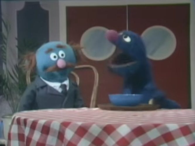 Mr. Johnson and Grover in a restaurant.