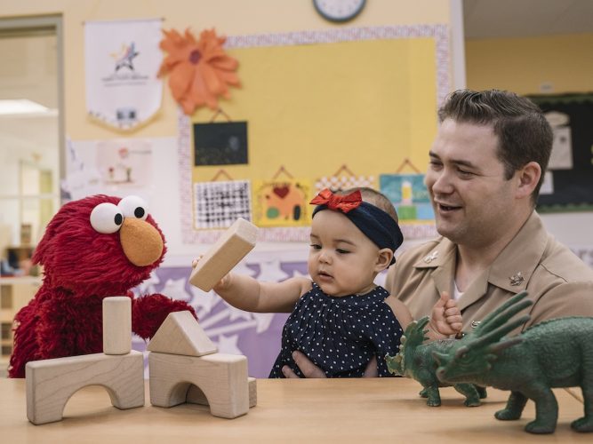 Elmo with a child and parent.