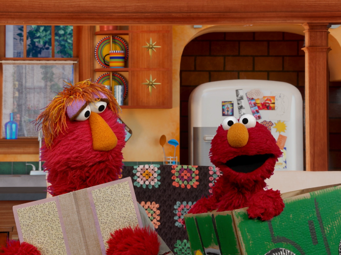 Elmo and Louie reading together.