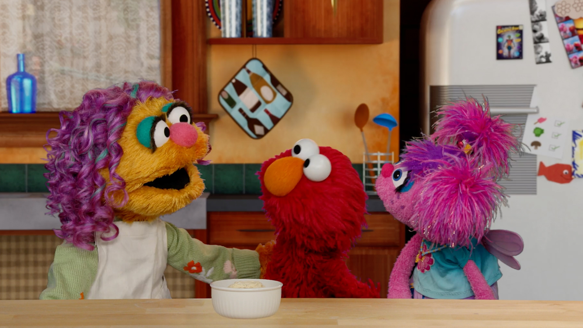 May, Elmo and Abby in a kitchen
