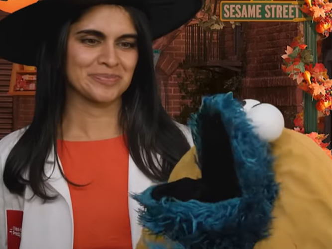 A doctor and cookie monster in a costume.