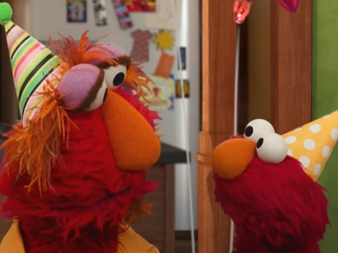Elmo and Louie in party hats.