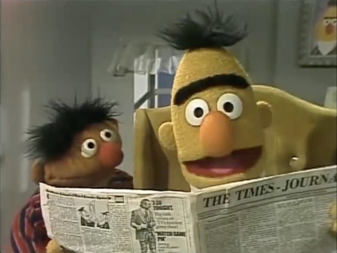 Bert and Ernie reading a newspaper.