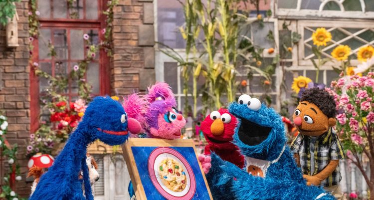 Cookie Monster, Abby, Elmo and Grover with a picture of a cookie.
