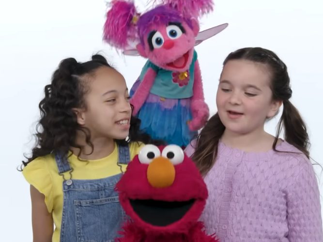Elmo and Abby singing with friends.