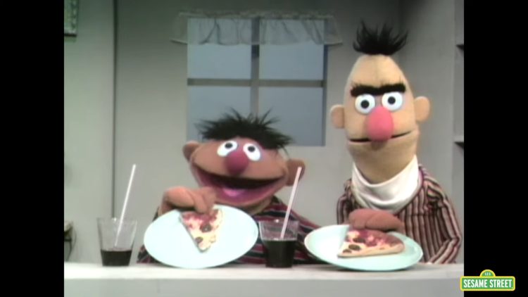 Bert and Ernie with pizza