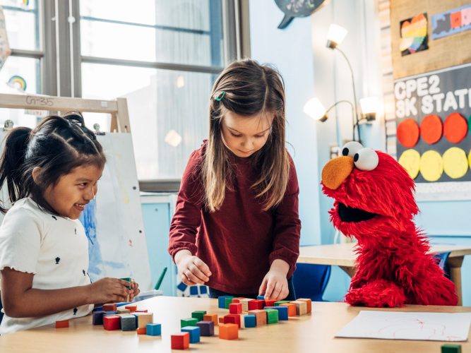 A child playing with Elmo.