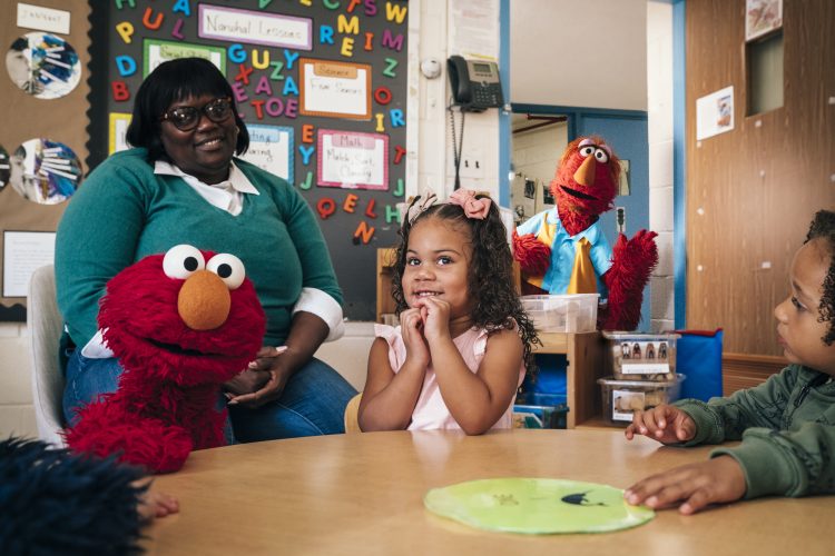 Building Healthy Minds and Hearts Early, a caregiver with a child and the sesame characters