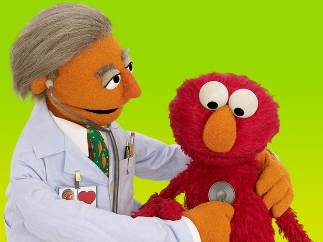 A doctor with Elmo.