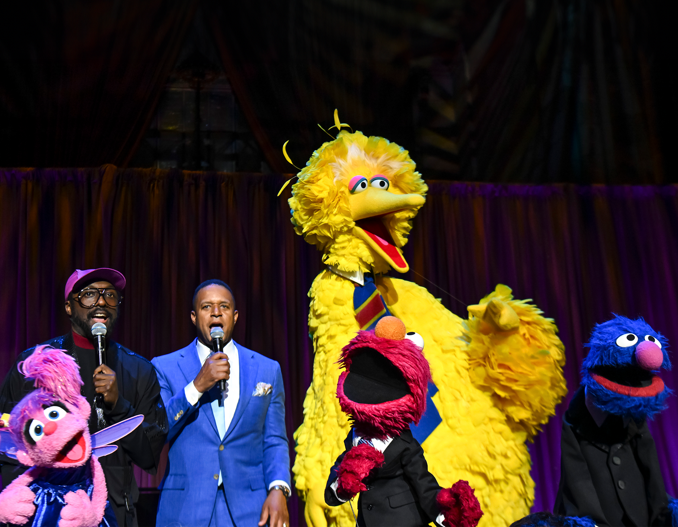 Will.i.am and Craig Melvin with Sesame characters