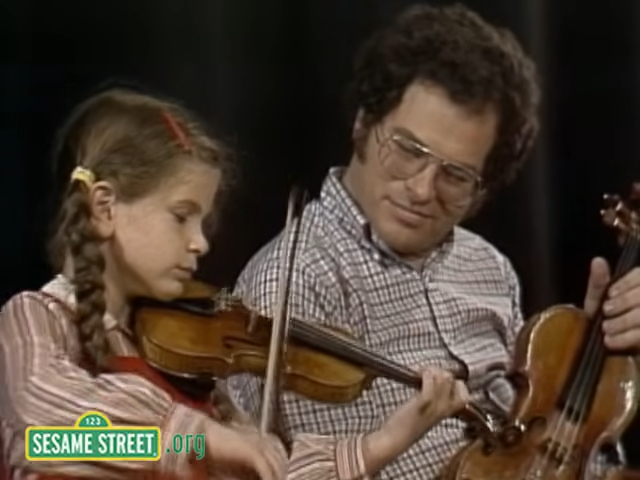 Itzhak Perlman and a child playing the violin.
